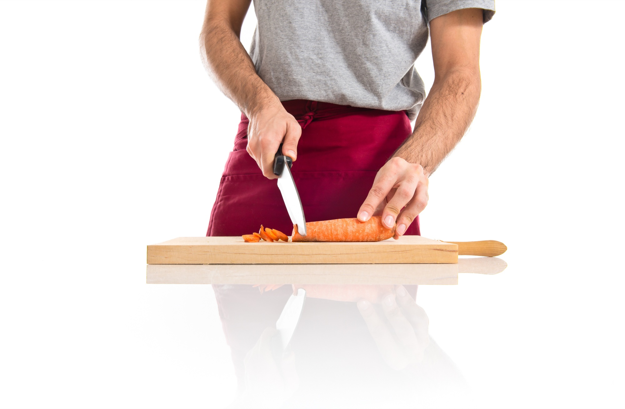 Student learning knife skills on cutting board