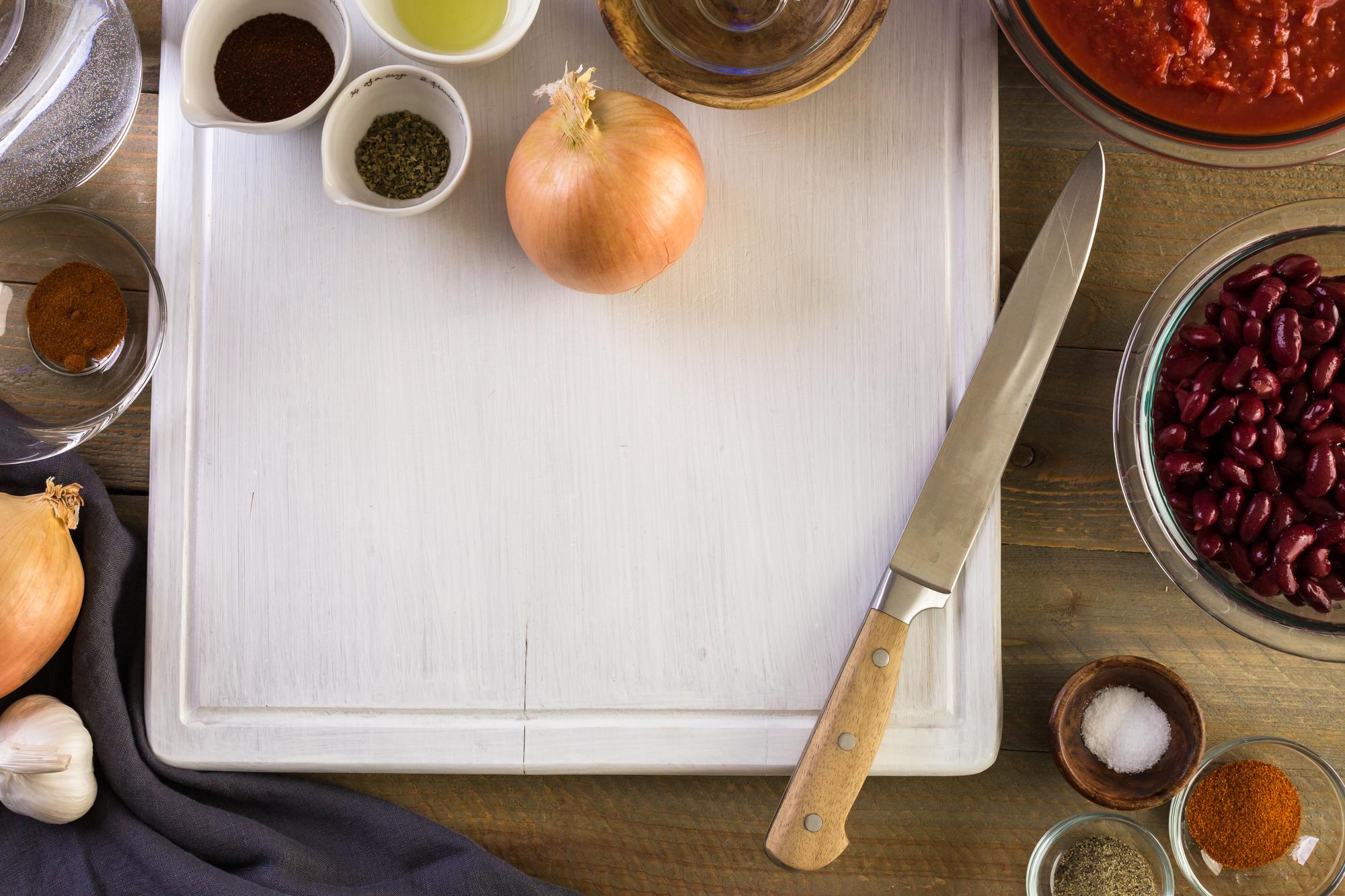 Row of utensils and recipe notes on paper
